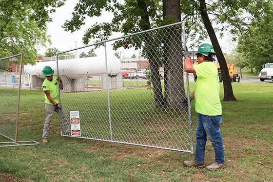 two men installing a fence