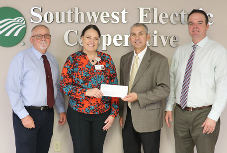 Wren Hall accepting donation from James Ashworth, Southwest Electric Cooperative 
