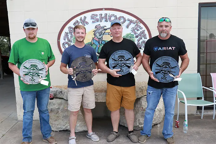 four men holding metal signs